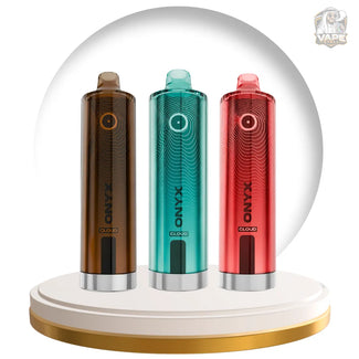 Three XXANG Cloud vape devices in brown, teal, and red, displayed on a gold-rimmed white circular stand against a white background with a faint gray arch.