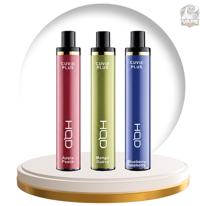 Three Cuvie Plus vape devices in Apple Peach, Mango Guava, and Blueberry Raspberry flavors, displayed on a gold and white circular pedestal against a white background with a circular graphic backdrop.