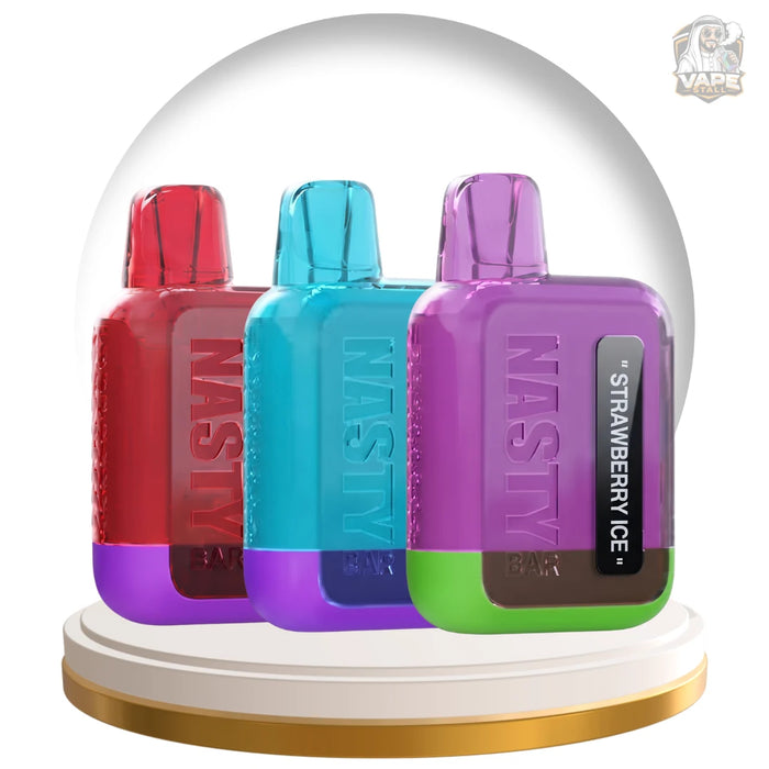 Three NASiY vape devices in red, cyan, and purple, displayed inside a clear dome on a white and gold pedestal. The front device is purple with a green bottom and a black label reading 'Strawberry Ice'.