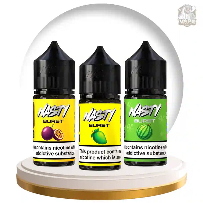 Three bottles of NASTI BURST e-liquid in a circular display on a white pedestal with a gold rim. The bottles have black caps and labels in yellow and green, showing fruit and watermelon graphics respectively.