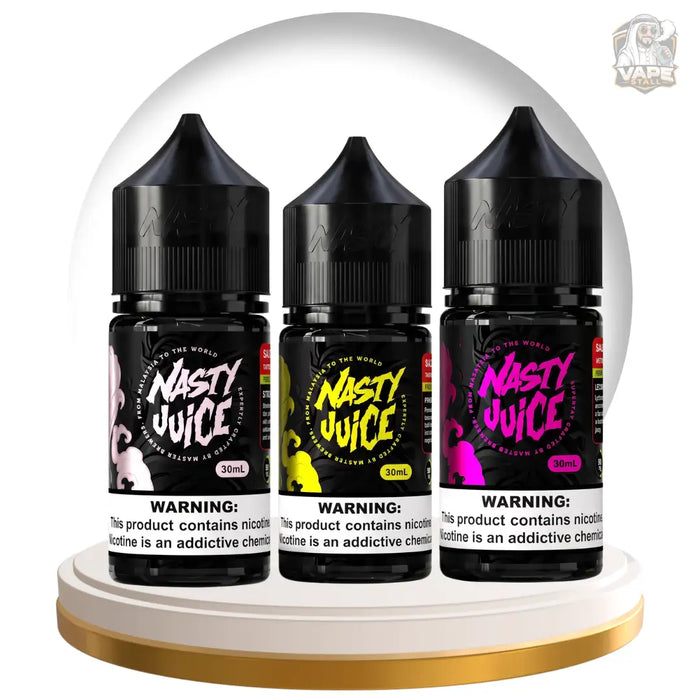 Three bottles of Nasty Juice disposable vape devices lined up on a white circular pedestal with a gold rim, under a clear dome. The bottles are black with colorful labels (pink, yellow, and purple designs) and feature prominent warning labels at the bottom.