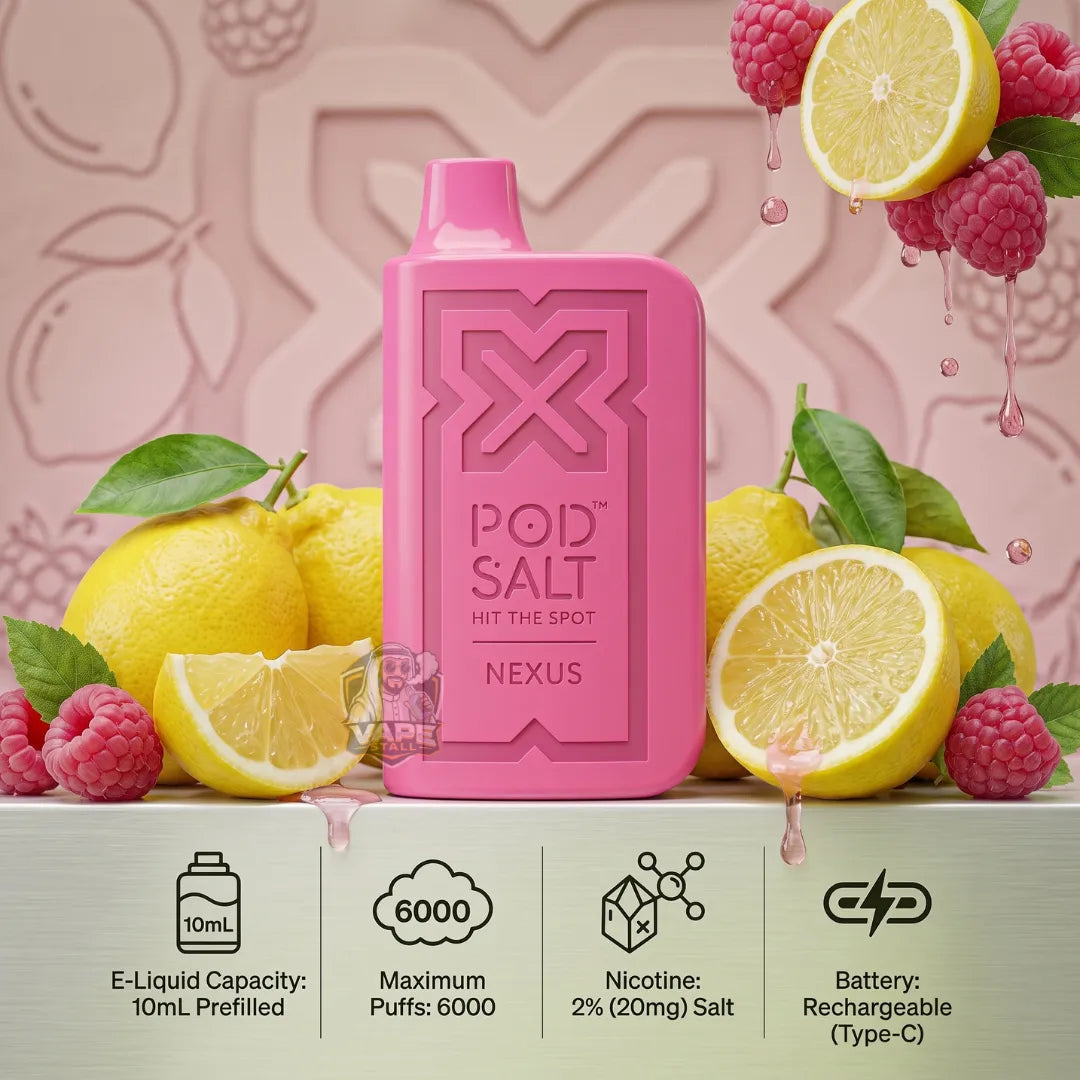 Pink POD SALT Hit The Spot Nexus e-liquid bottle centered on a light gray surface, surrounded by lemons, raspberries, and green leaves. The background is a soft pink with embossed leaf patterns, and feature icons at the bottom detailing product specs: 10mL e-liquid capacity, 6000 puffs, 2% nicotine salt, and rechargeable battery.