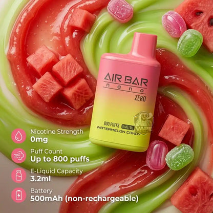 A pink-to-yellow AIR BAR nano Zero e-liquid bottle labeled Watermelon Candy, placed on a swirl of red and green watermelon-flavored liquid with watermelon cubes and candy pieces. Infographic text on the left lists nicotine strength, puff count, e-liquid capacity, and battery details.