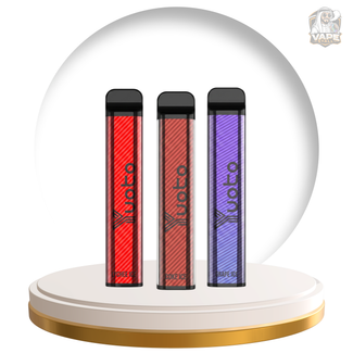 Three Uoto disposable vape devices standing upright on a round white and gold display pedestal, set against a large white circular backdrop. The vapes are shown in red, dark brown, and purple colors, each with a black mouthpiece and the Uoto brand name printed vertically.